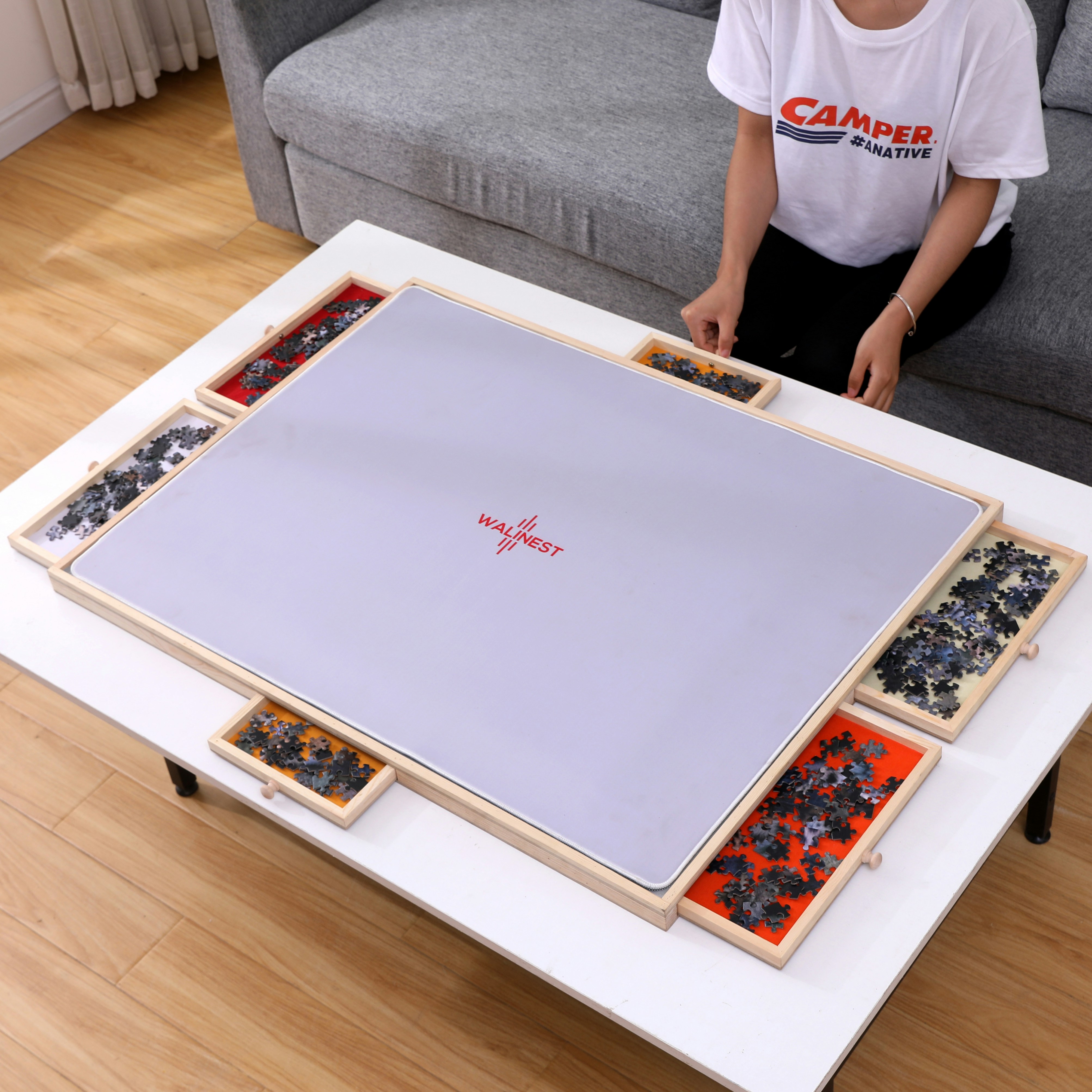a person sitting on a couch in front of a coffee table