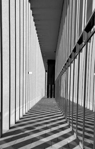 a black and white photo of a long hallway