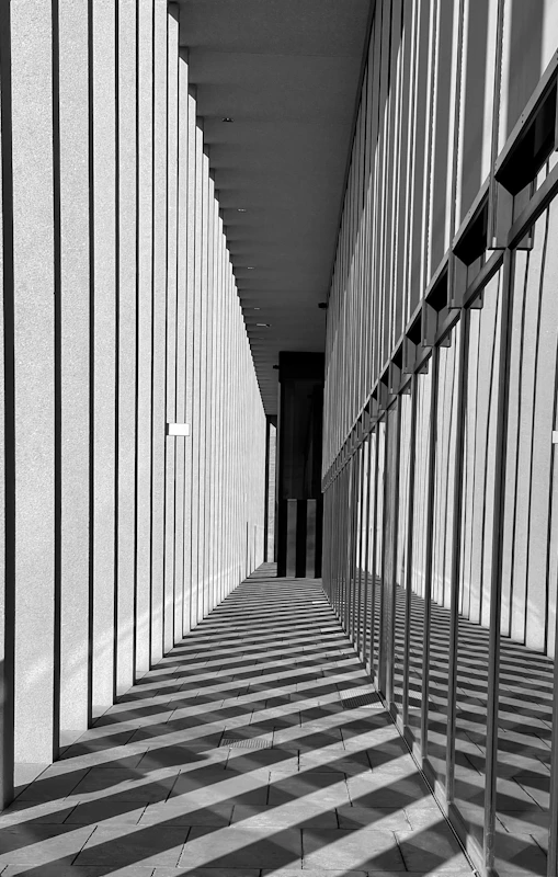 a black and white photo of a long hallway