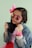a little girl wearing pink sunglasses and a jean jacket