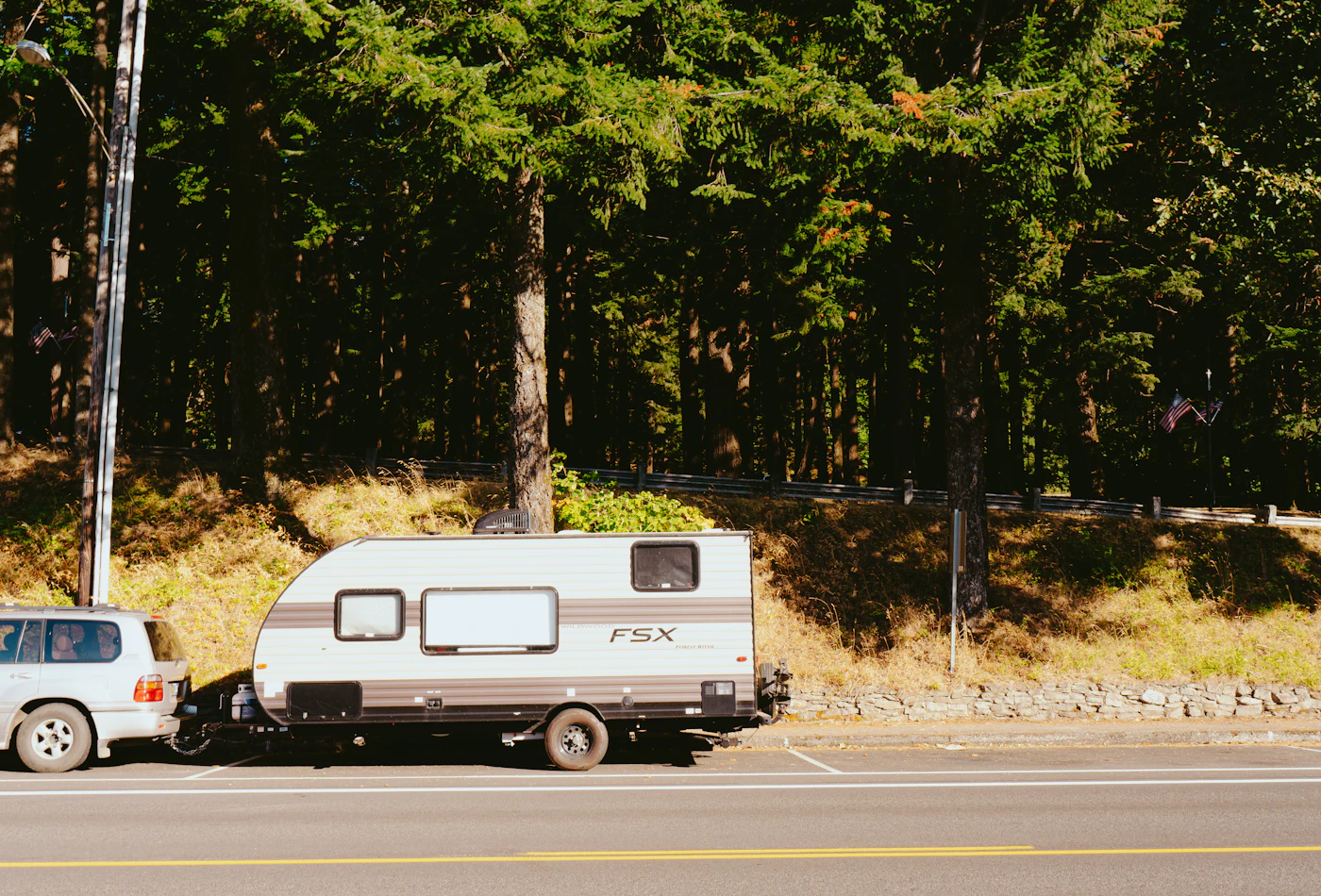 Pickup truck towing a travel trailer on the open road