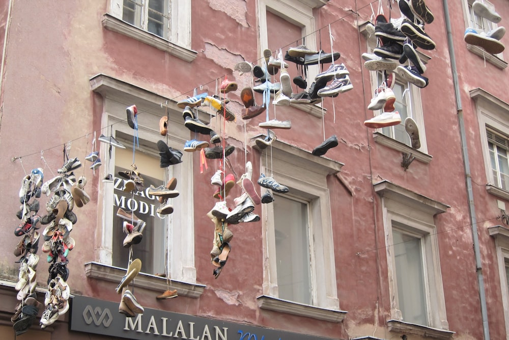 a building with a bunch of shoes hanging from the side of it
