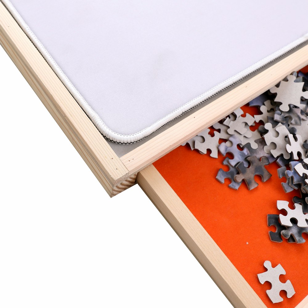 a pile of puzzle pieces sitting on top of an open book