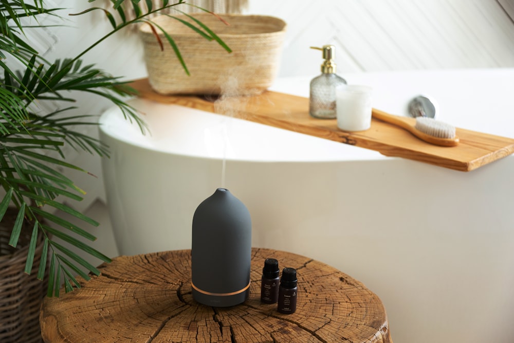 a white bath tub sitting next to a wooden table