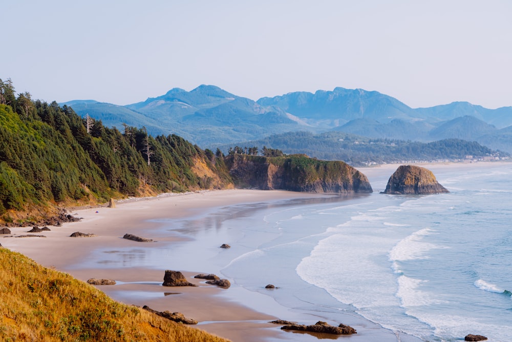 a view of a beach with mountains in the background