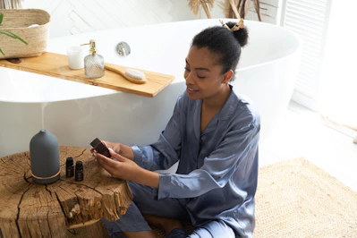 a woman sitting on a stool looking at her cell phone