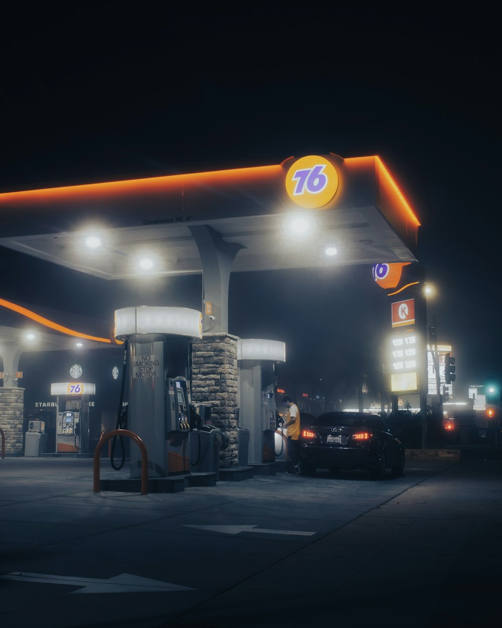 a gas station at night with lights on