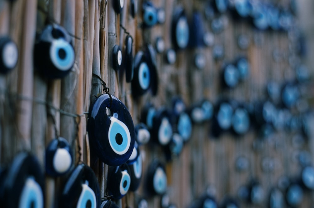 a close up of a bamboo wall with evil eyes on it