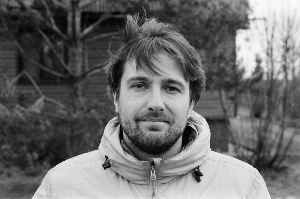 a black and white photo of a man with a beard