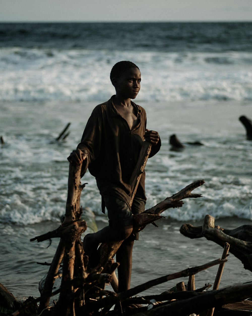 a man standing on a beach next to the ocean