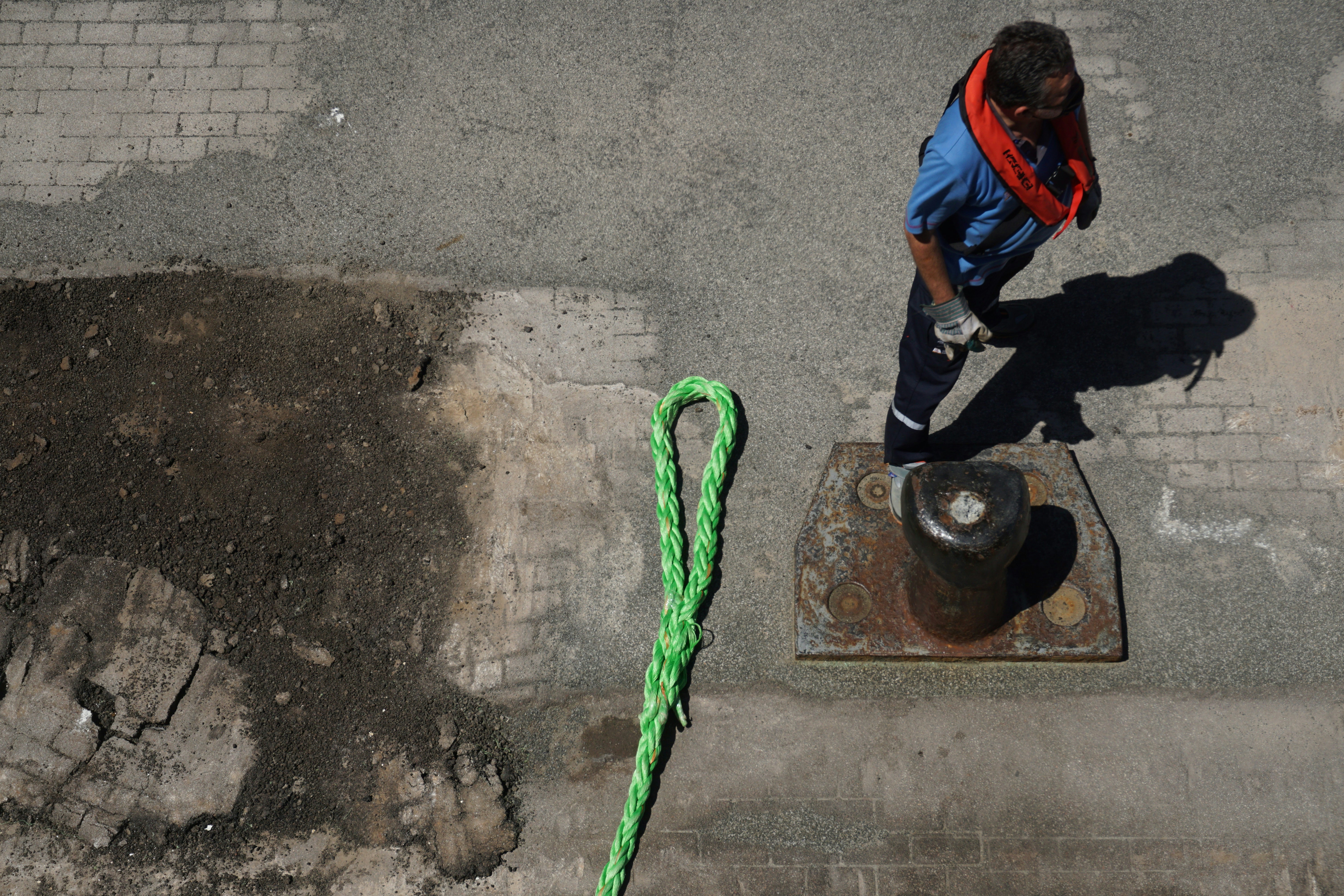 a man walking down a street next to a fire hydrant