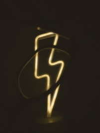 a close up of a neon sign in the dark