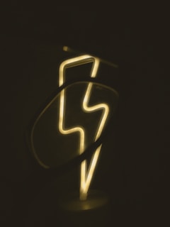 a close up of a neon sign in the dark