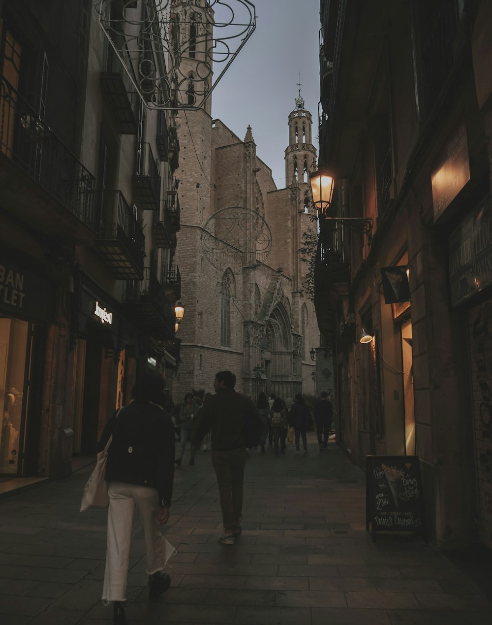 a couple of people that are walking down a street