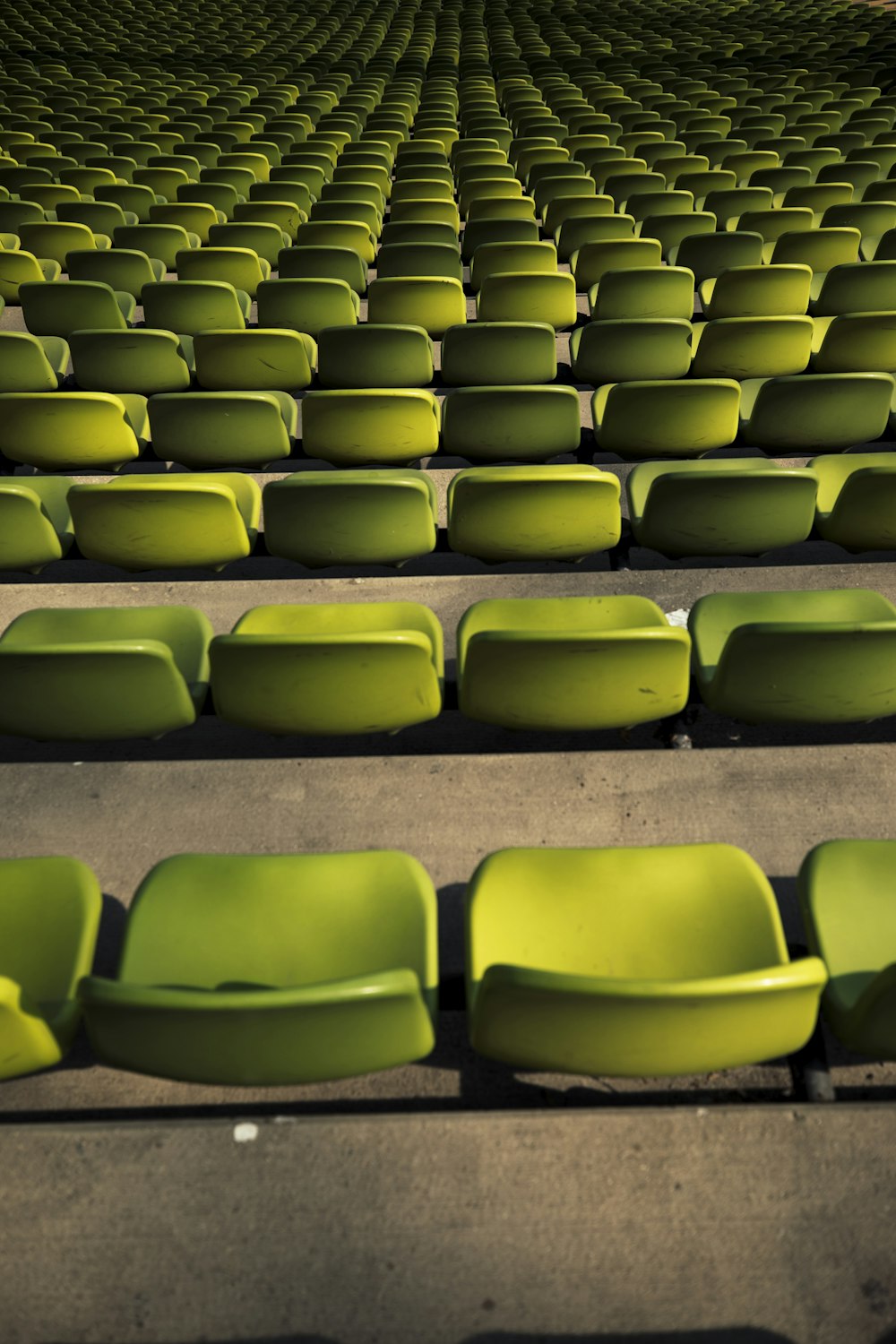 a row of green seats sitting next to each other