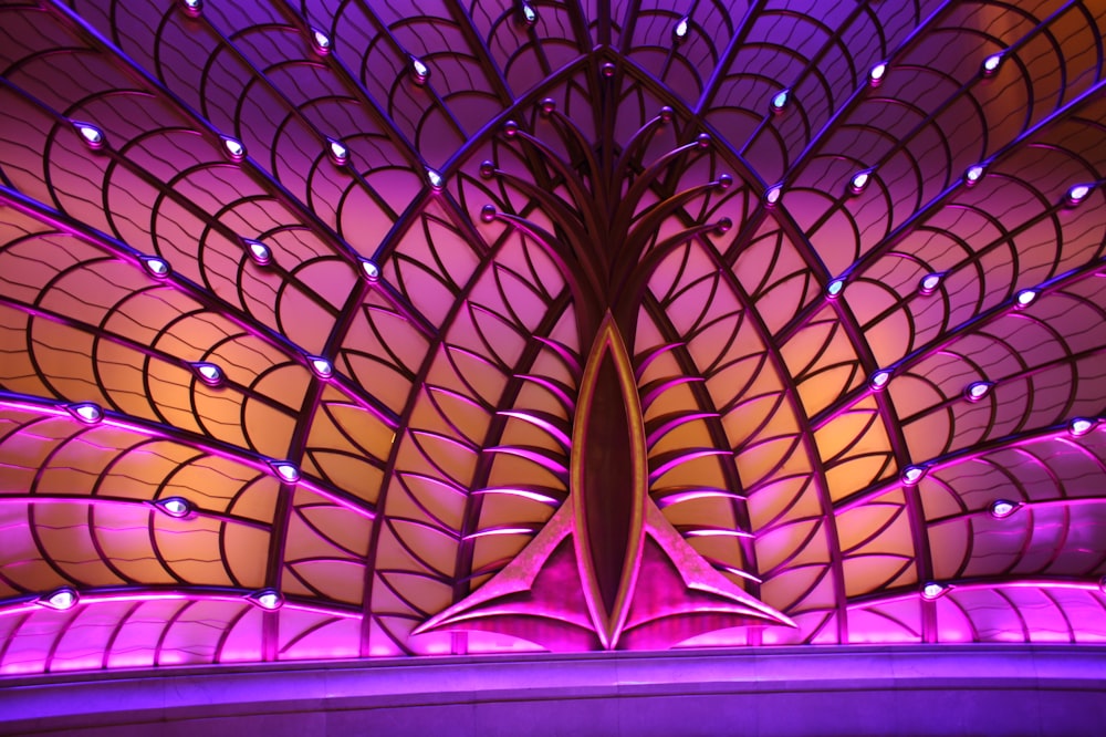 a large purple and yellow sculpture with lights on it