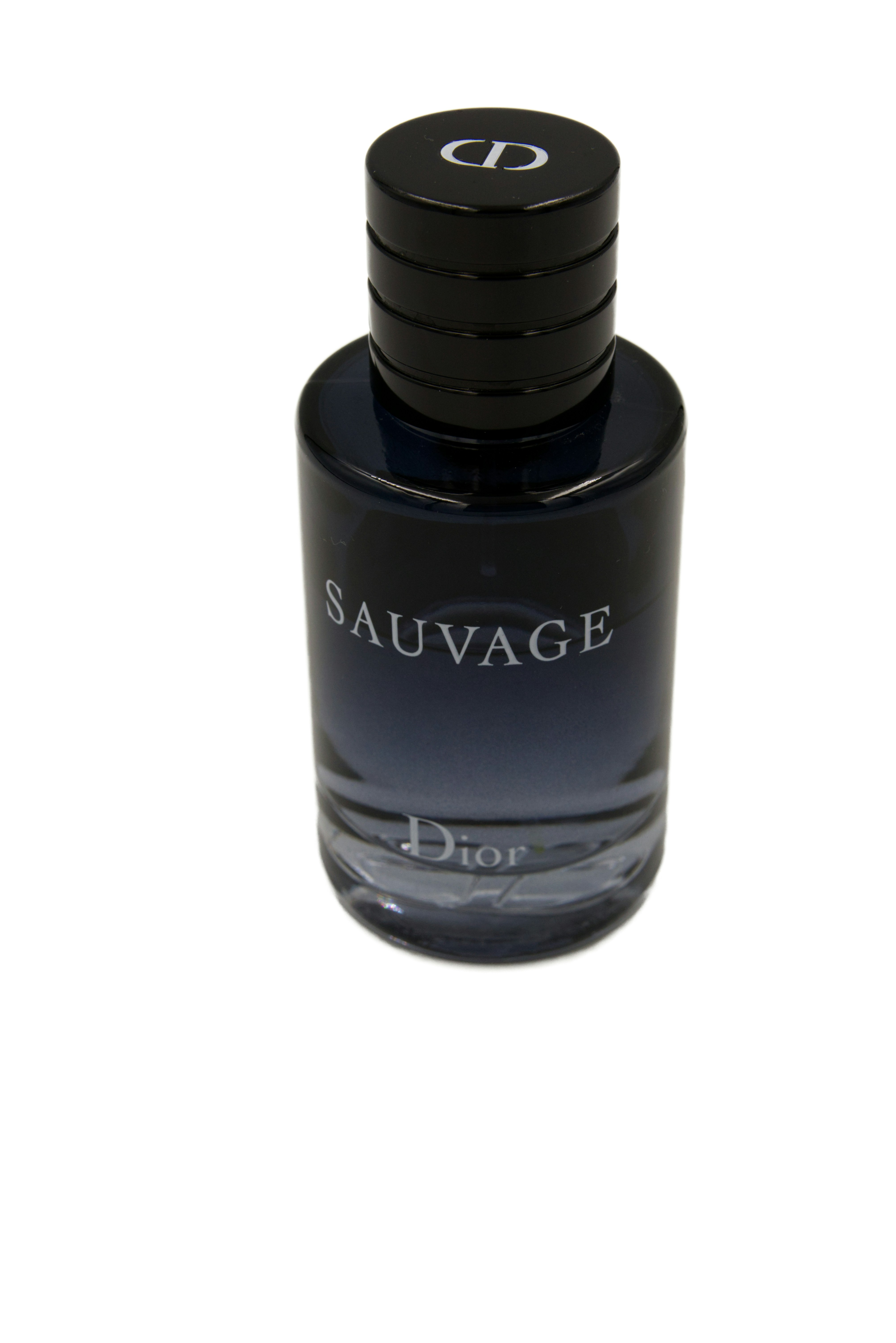 Dior Sauvage perfume bottle with dark blue cap on a clean dark background with soft rim lighting