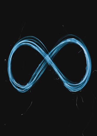 A glowing blue infinity symbol drawn against a black background using light trails.