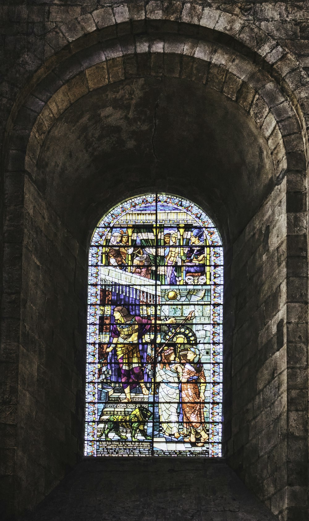 a large stained glass window in a stone building