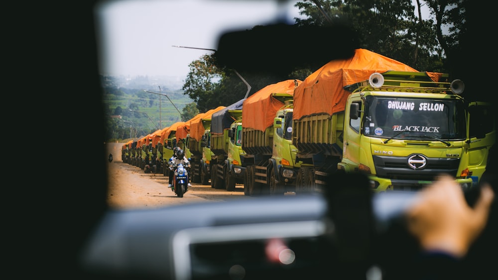 a line of trucks parked on the side of a road