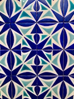 a close up of a blue and white tiled wall