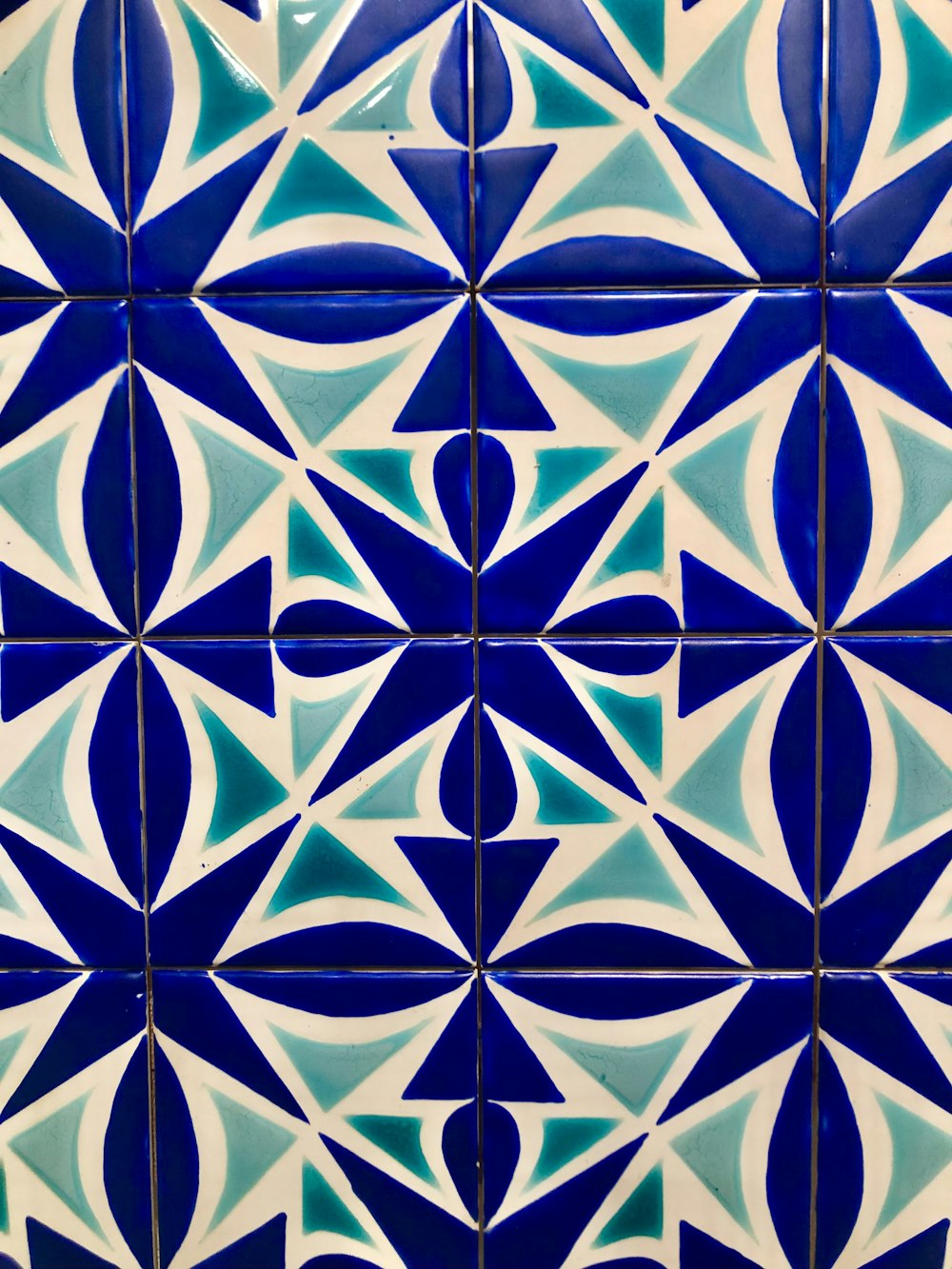 a close up of a blue and white tiled wall