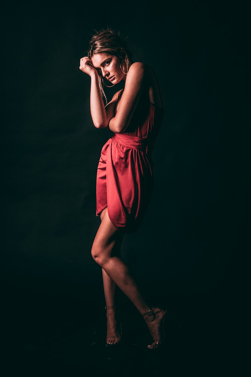 a woman in a red dress posing for a picture