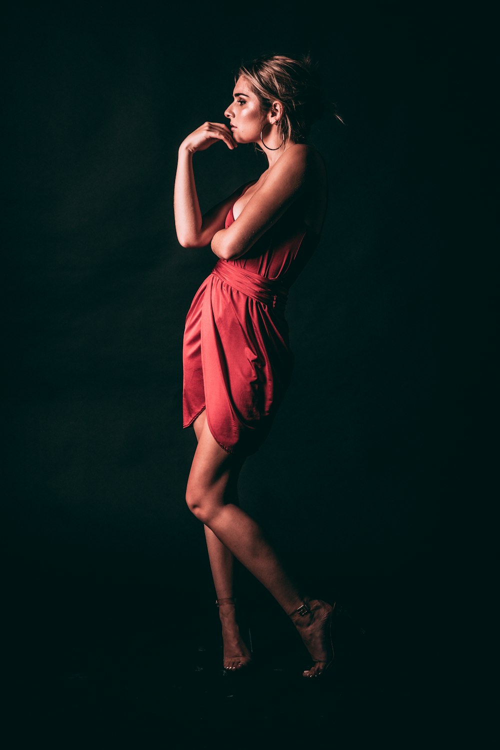 a woman in a red dress posing for a picture