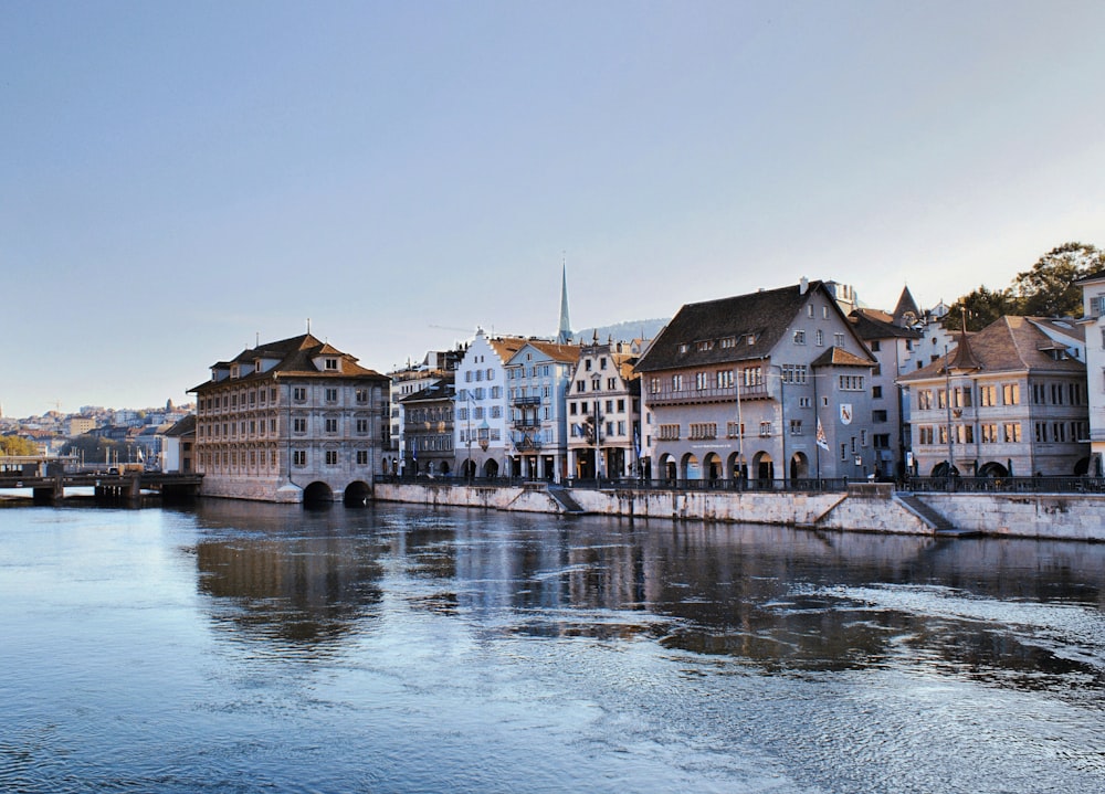 a river running through a city next to tall buildings