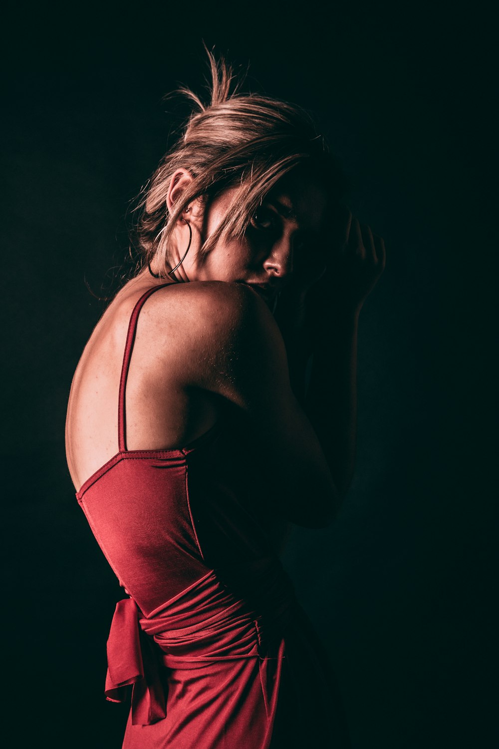 a woman in a red dress posing for a picture