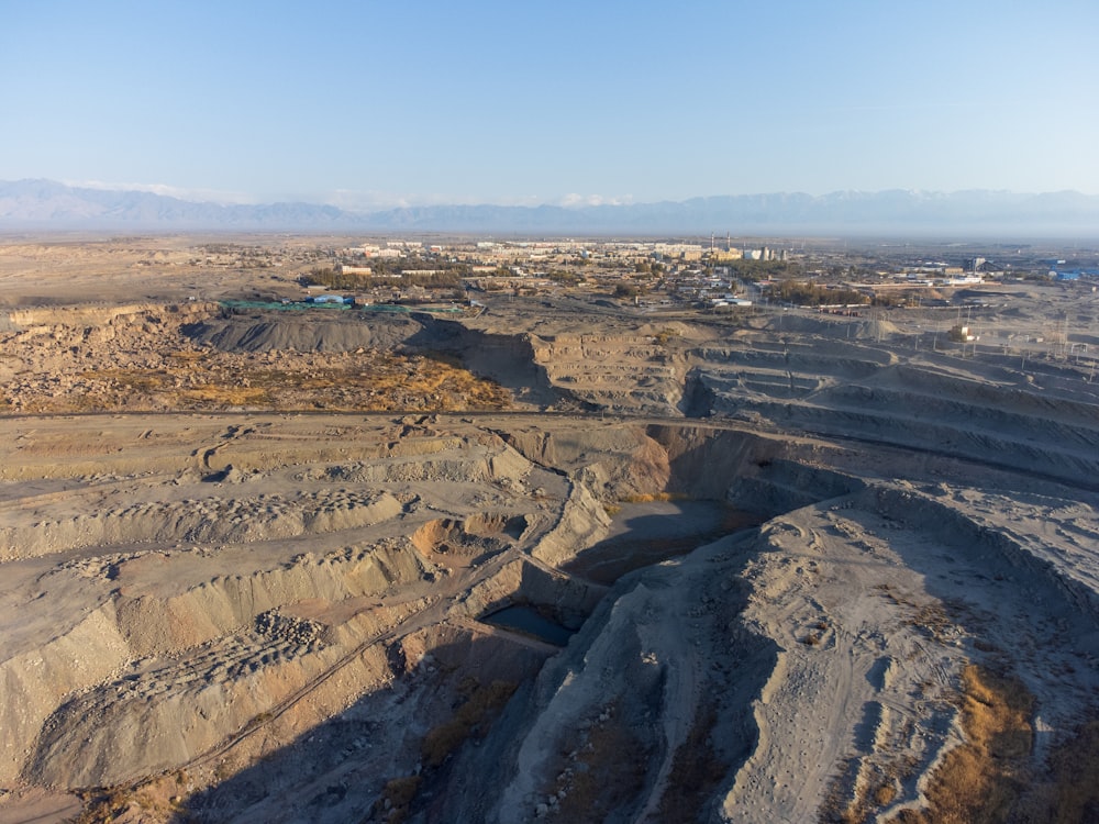 an aerial view of a desert landscape with mountains in the background