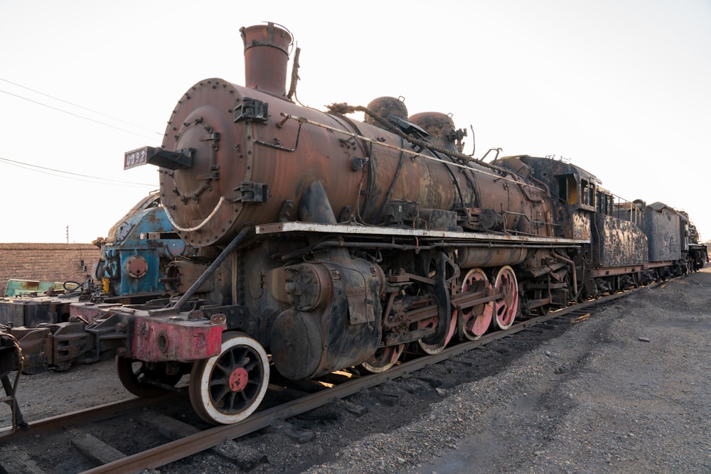 an old train is sitting on the tracks