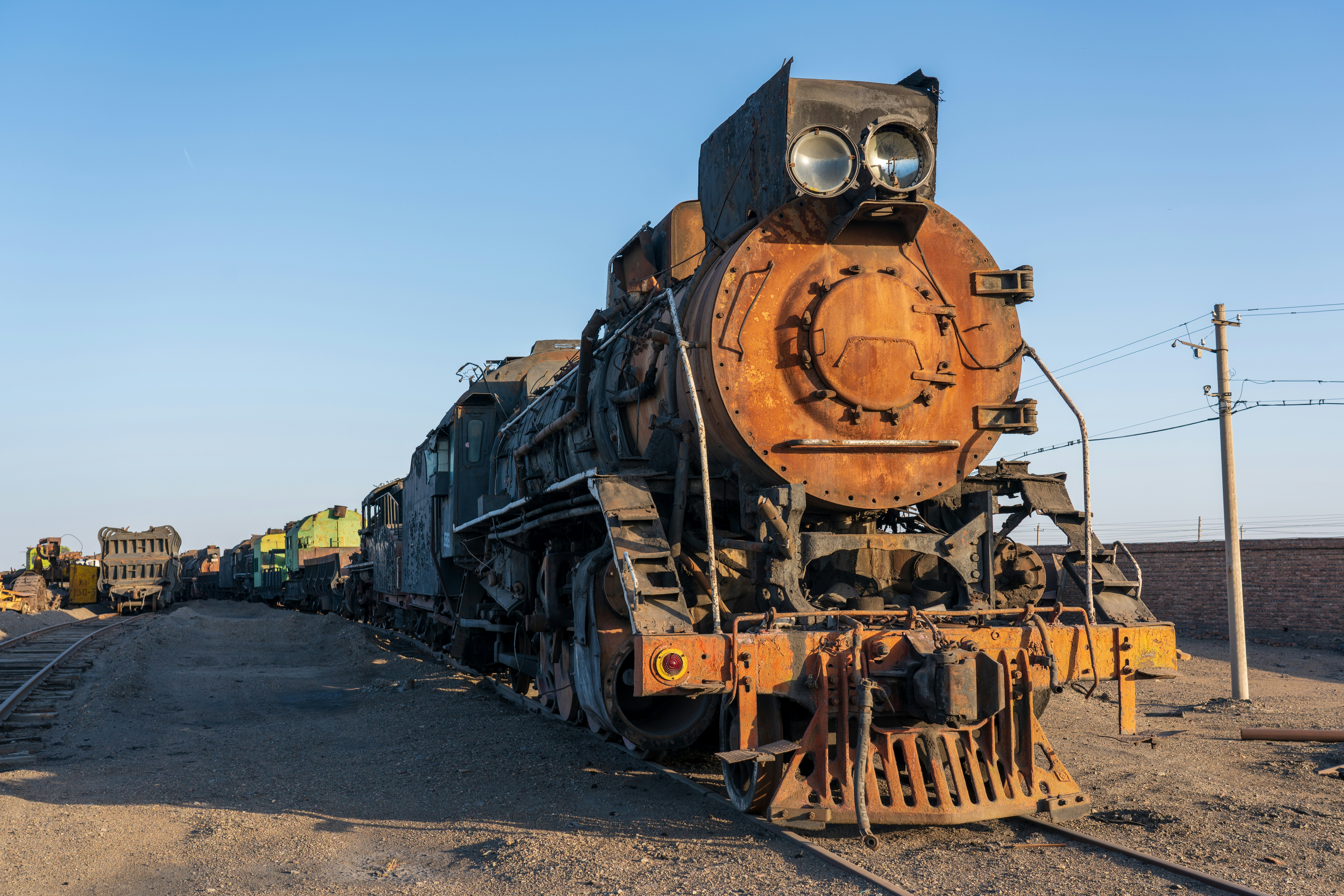an old train sitting on the tracks in the middle of nowhere