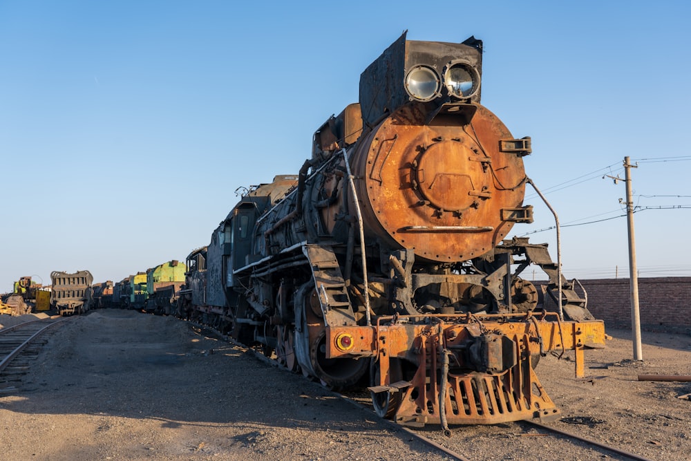 an old train sitting on the tracks in the middle of nowhere