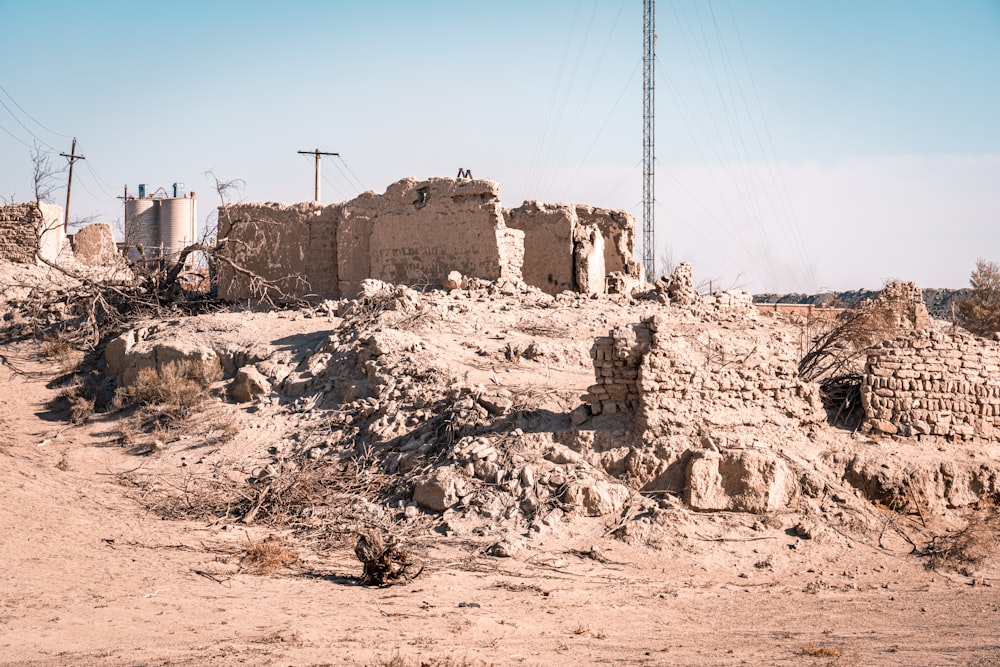 a dirt field with a building in the middle of it