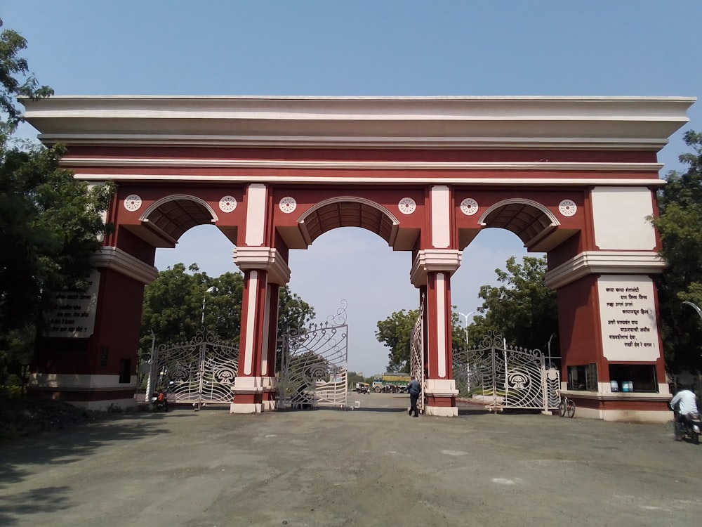 a red and white arch with a sign on it