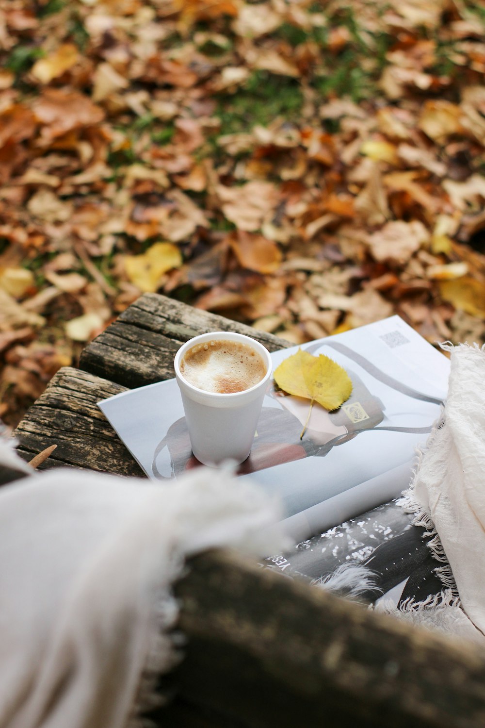 a cup of coffee sitting on top of a wooden table