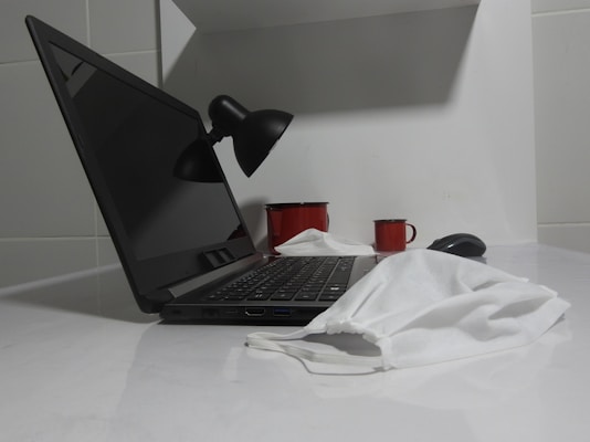 a laptop computer sitting on top of a white counter