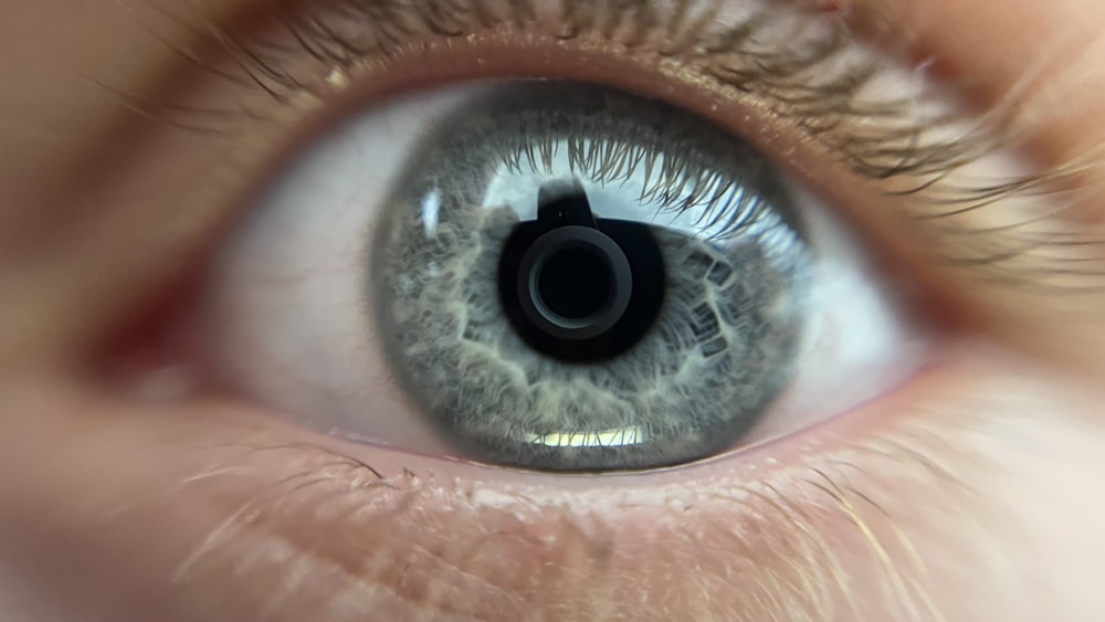 a close up of a person's blue eye