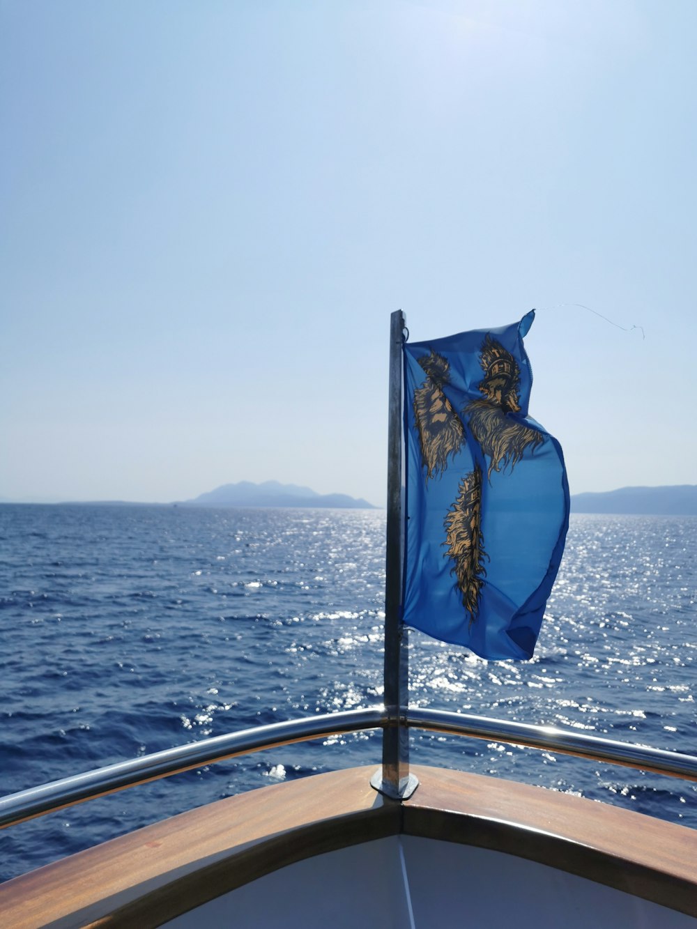 a blue flag on a boat in the ocean