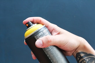 a person holding a black and yellow water bottle