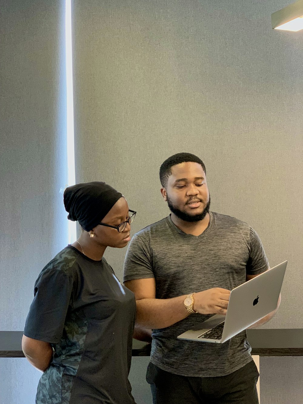 a man and woman looking at a laptop