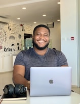 a man sitting in front of a laptop computer