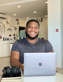 a man sitting in front of a laptop computer