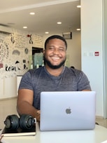 a man sitting in front of a laptop computer