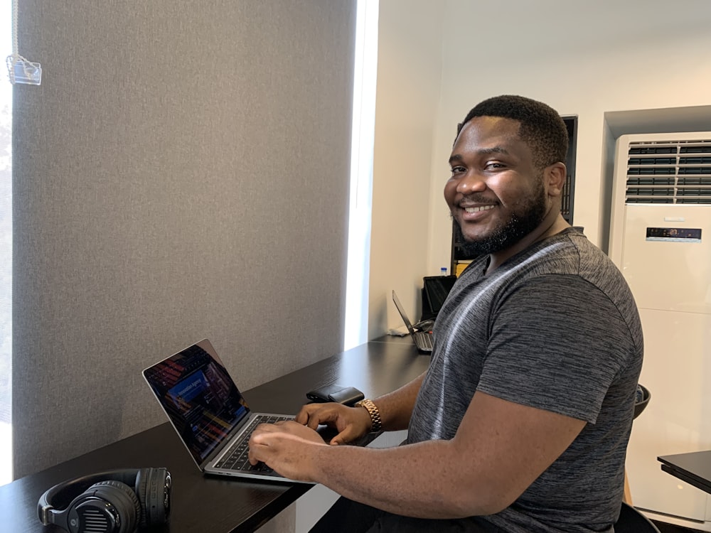 a man sitting at a desk with a laptop