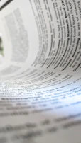 a close up of a book with a pen on top of it