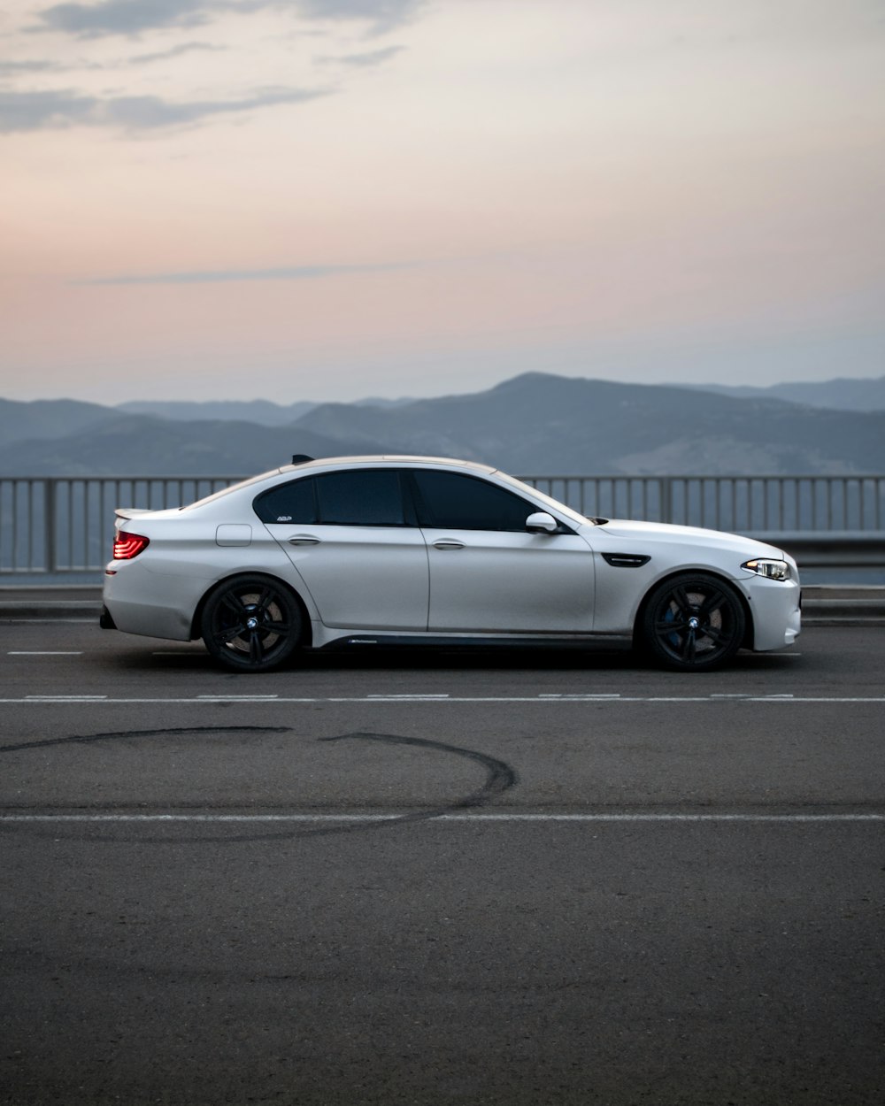 a white car parked on the side of a road