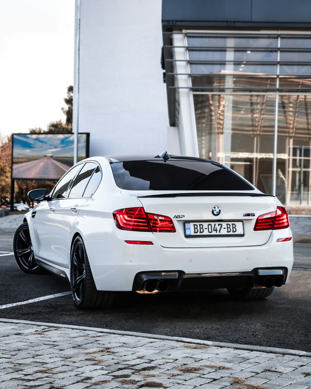 a white car parked in front of a building