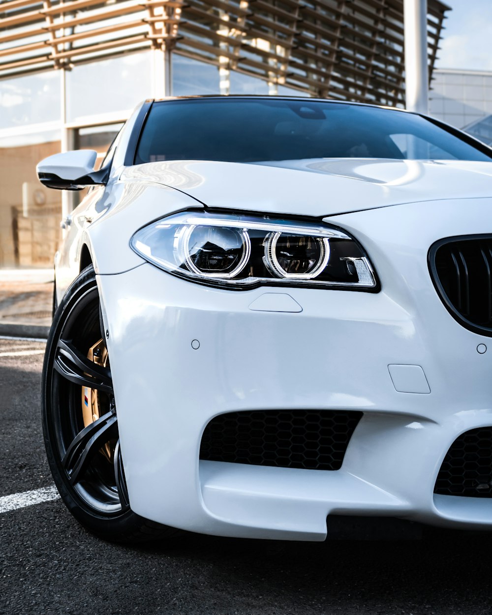 a white car parked in front of a building